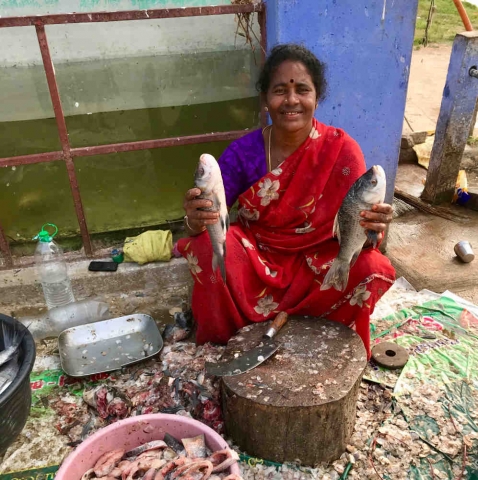 Lady selling fish at riverside