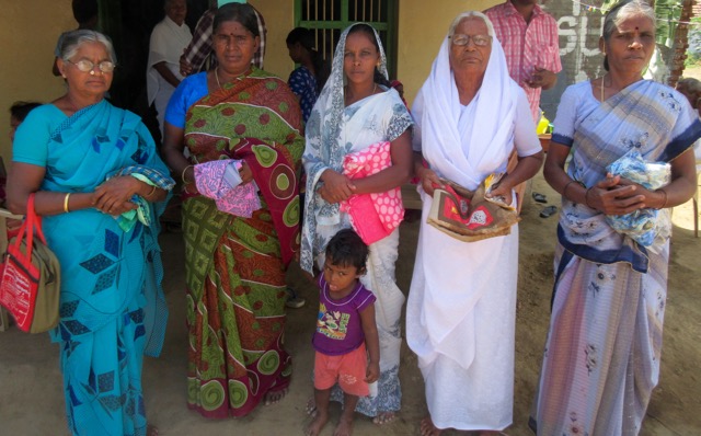 Widows holding their new saris