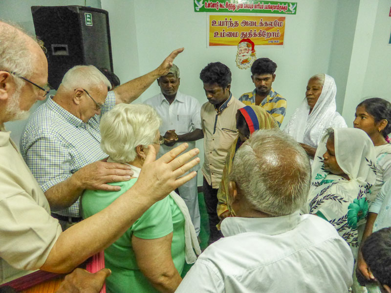 Prayer group after rural church service in India