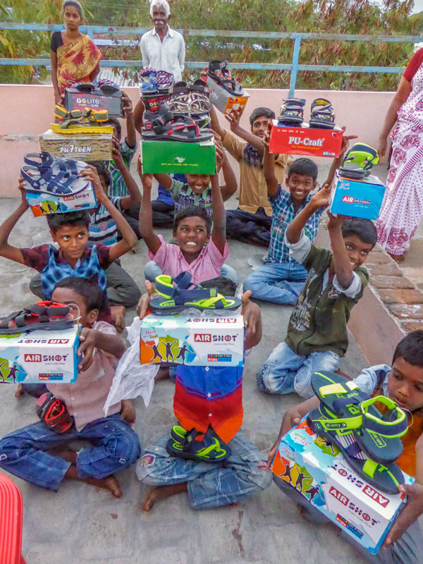 Happy orphans having received new shoes