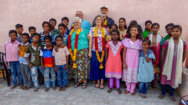 Group photo of Mission Team with happy orphans