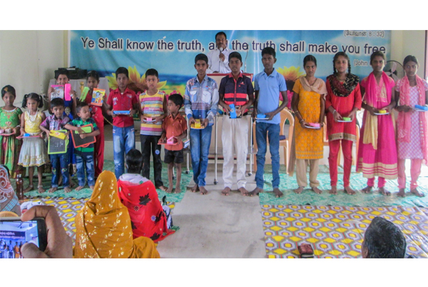 Indian children with gifts at holiday bible club
