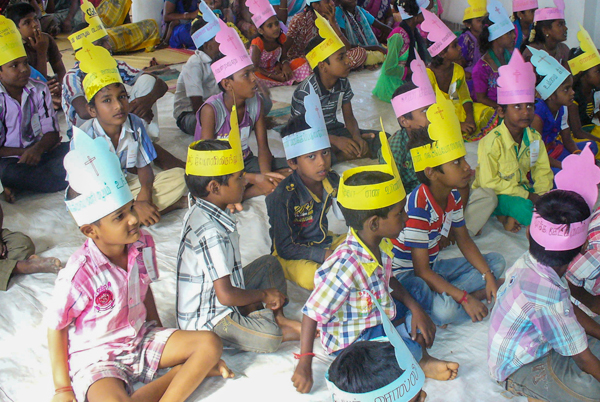 Indian Children wearing craft hats at holiday bible club