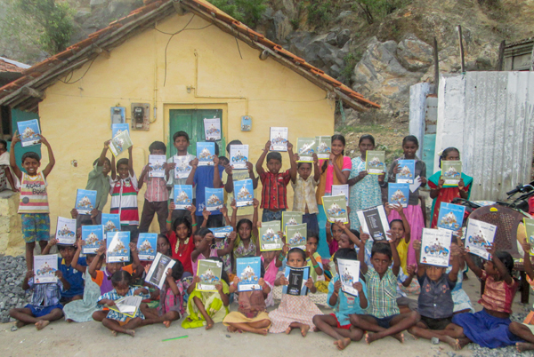 Happy Indian children gathered with VBS work books