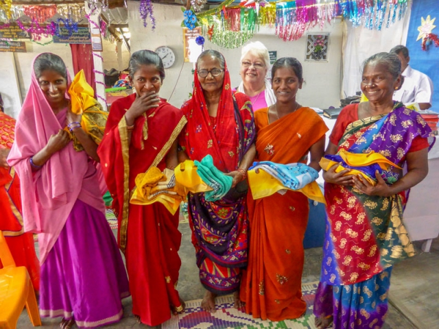 Grateful widows holding their new saris